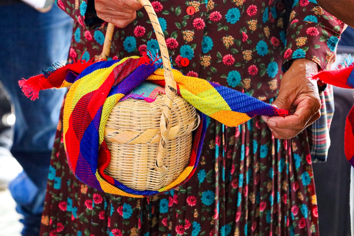 A gift of honey in a basket, wrapped in a colorful headscarf from the COMIPRONIL coffee cooperative in Honduras.