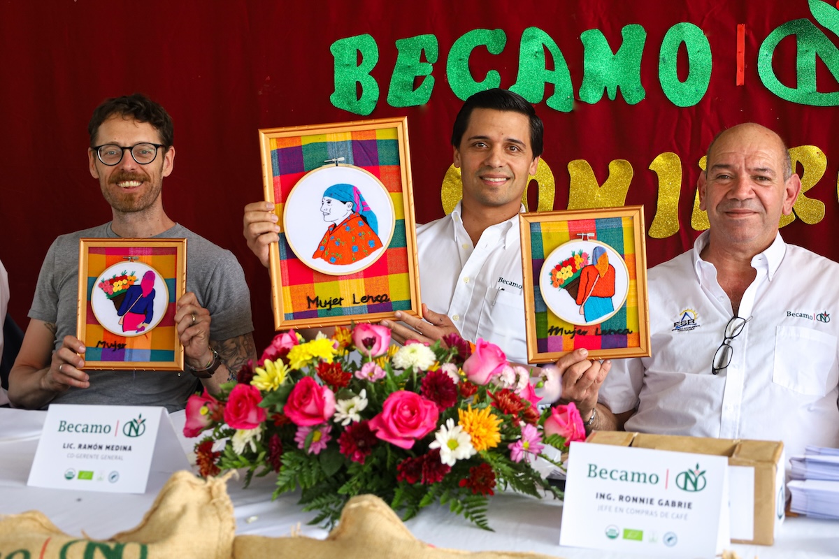 Coffee team posing with gifts created for them by the women coffee producers they purchase from. 